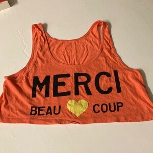 Merci Beau Coop French words printed in black on Orange Tank Crop Top